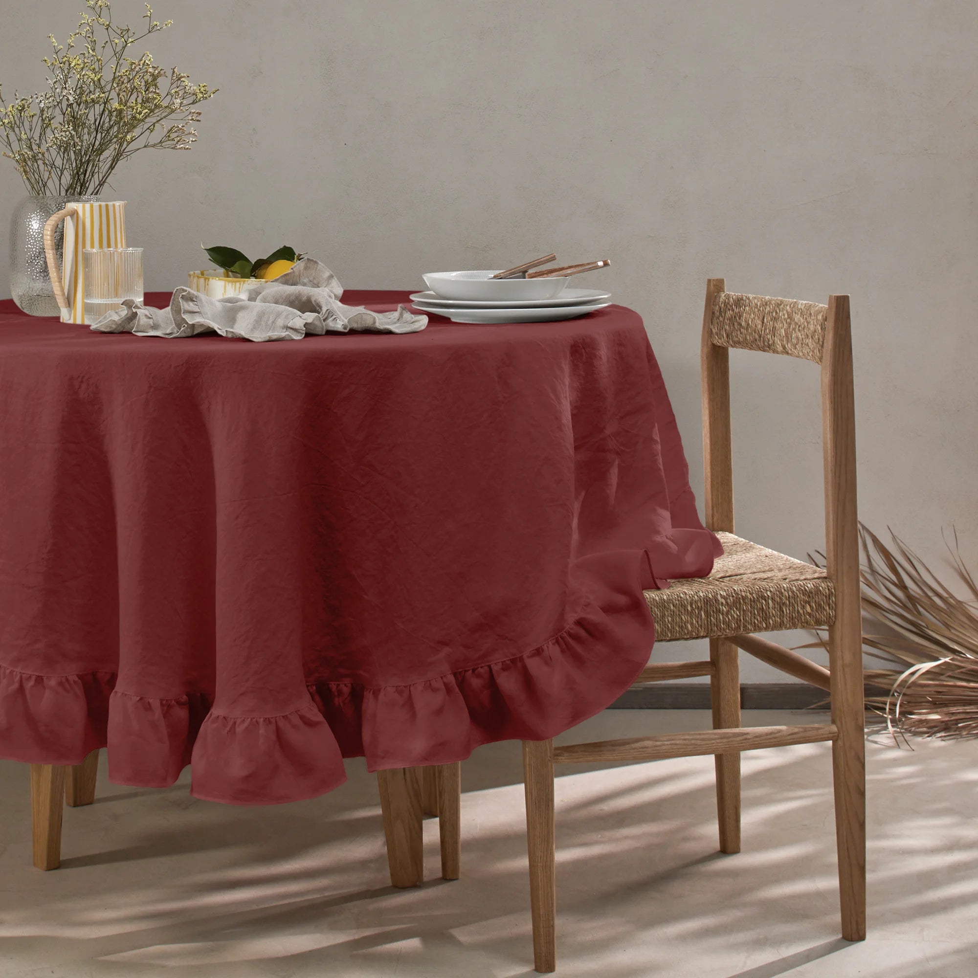 Made to order oval ruffled tablecloth in brick red linen | Linenshed