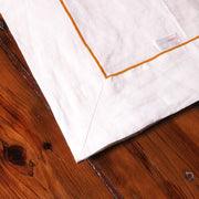 Close up linen tablecloth with bourdon border